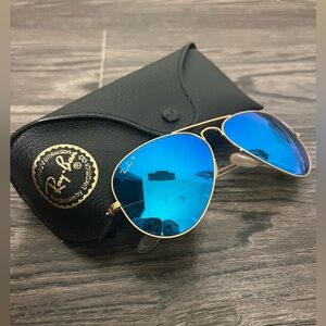 Ray-Bans blue reflective aviator style with gold hardware;polarized